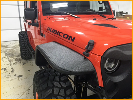 Front fenders, grill, front and rear bumper of Jeep Rubicon sprayed with GatorHyde polyurea