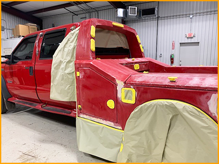 Red work truck bed sprayed with GatorHyde and topcoated with red urethane paint to match truck cab.