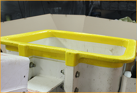 Utility truck boom bucket trim sprayed with GatorHyde.