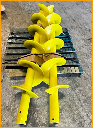  Large augers are spray coated with a polyurea coating.